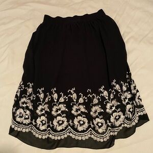 Black skirt with floral trim. Women’s Large